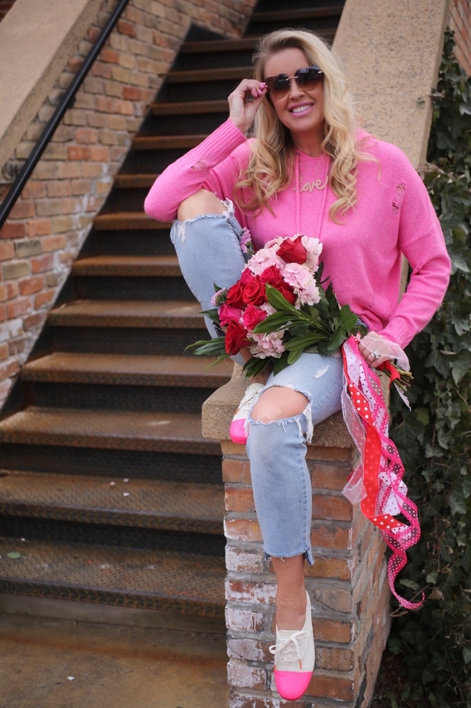 hot pink sweater, distressed jeans and fresh blooms
